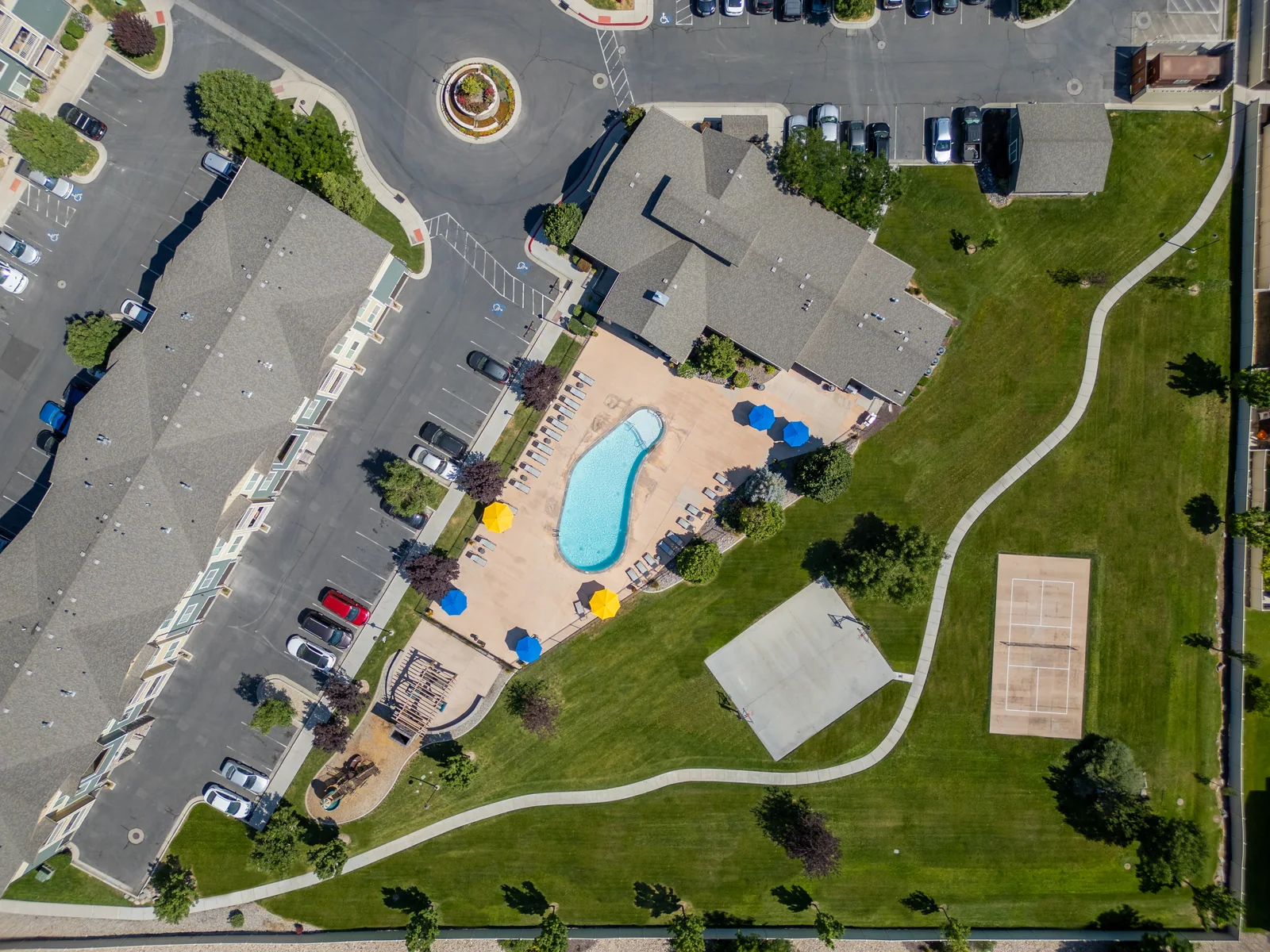 Aerial view of the Aldara clubhouse, pool, sport court and connected green spaces