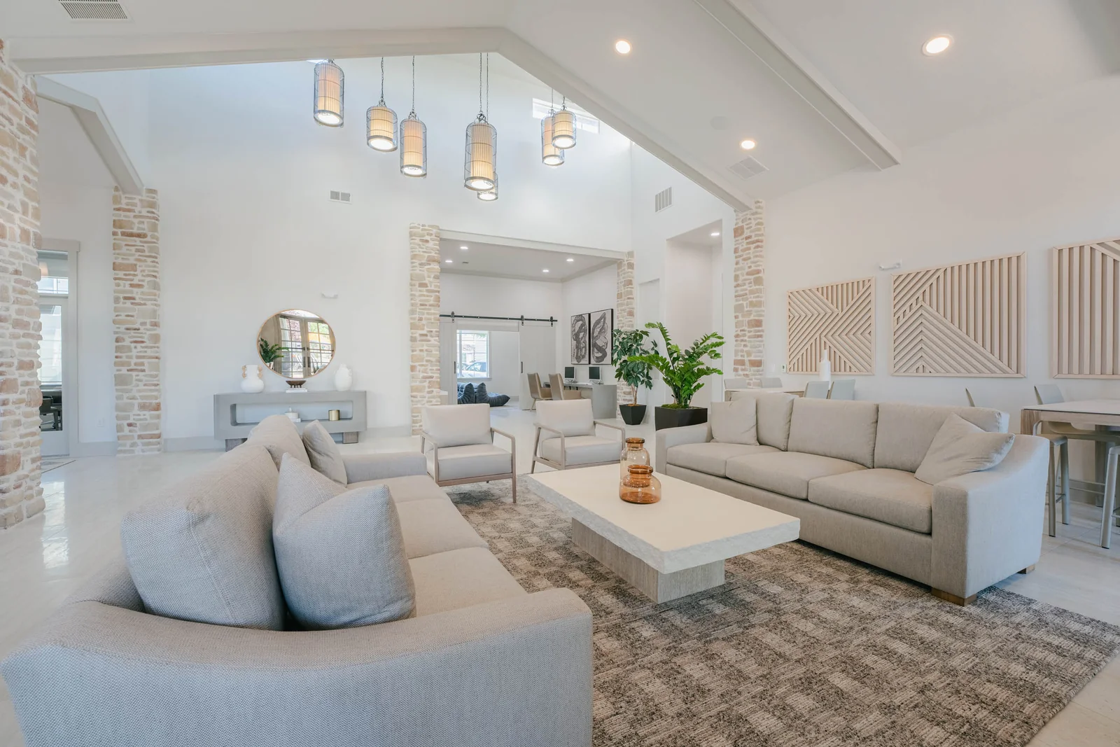 The bright Aldara clubhouse lounge with vaulted ceilings and wood details