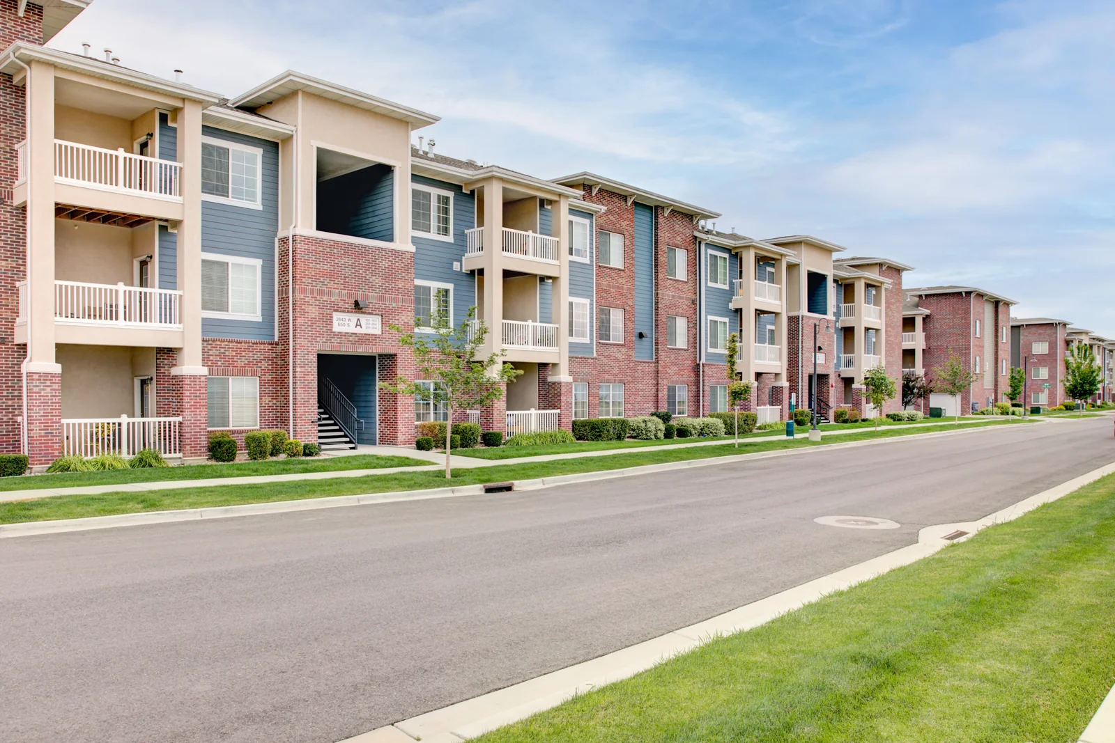 Brick apartment buildings and landscaped streetscape at Outlook